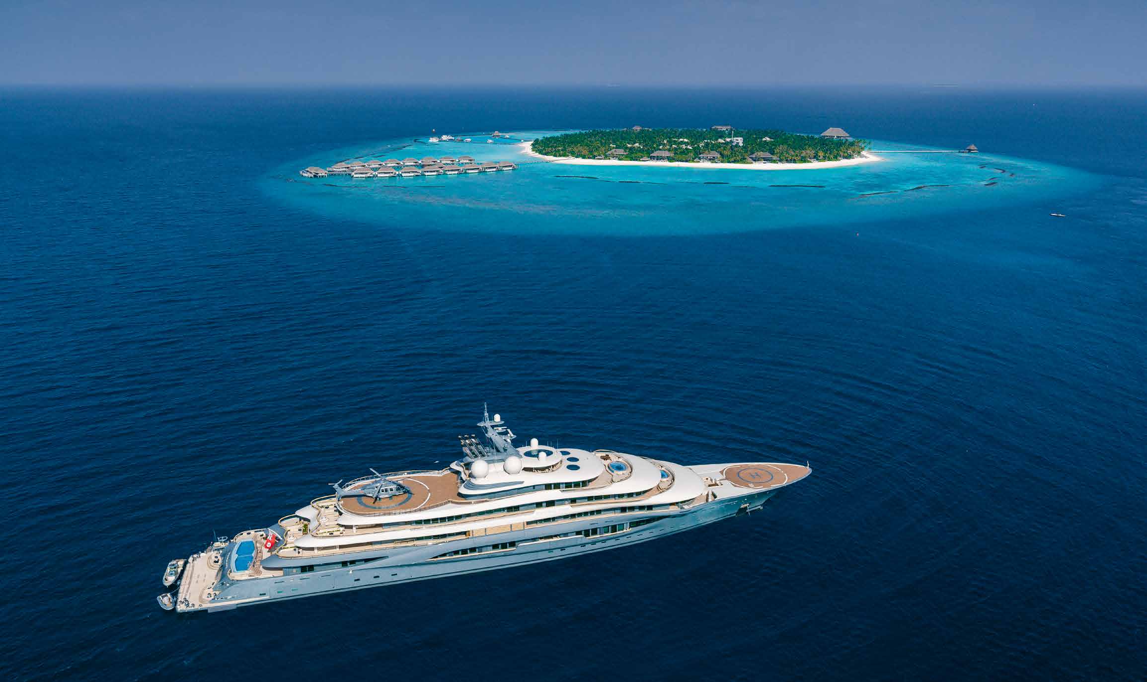 Flying Fox superyacht cruising beside a Maldivian island